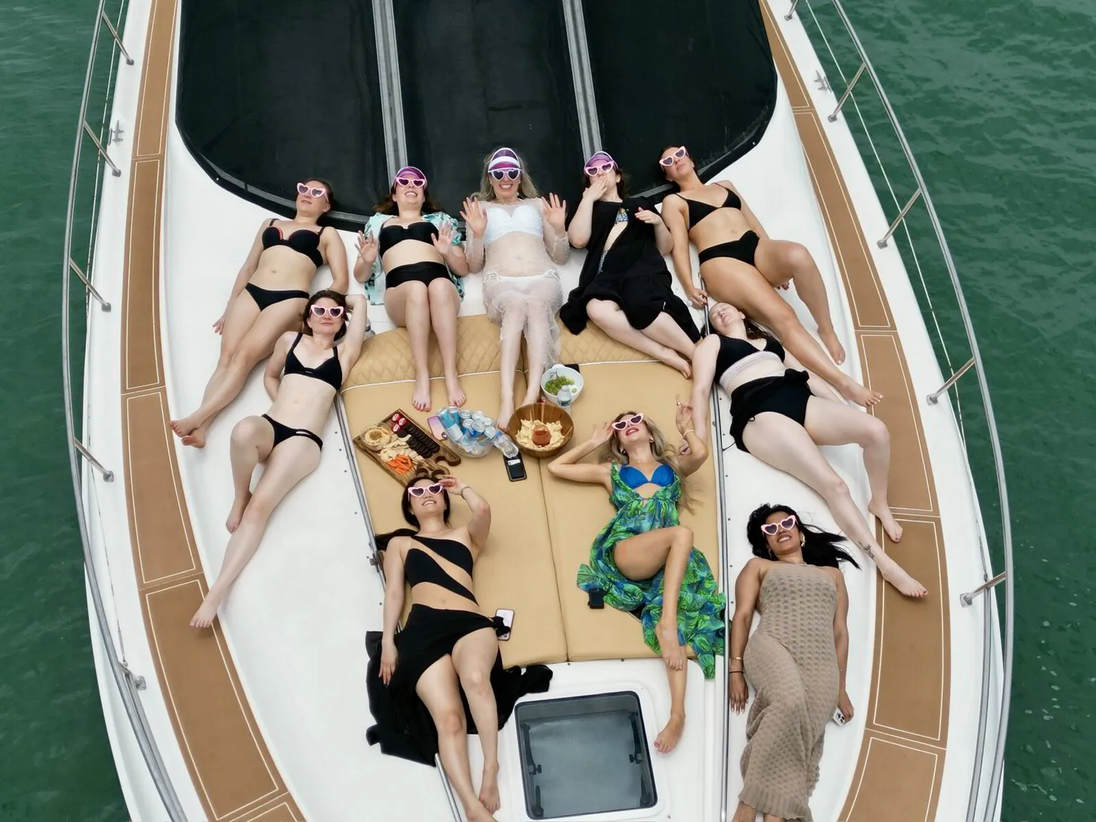 Aerial view of bachelorette party relaxing on yacht deck